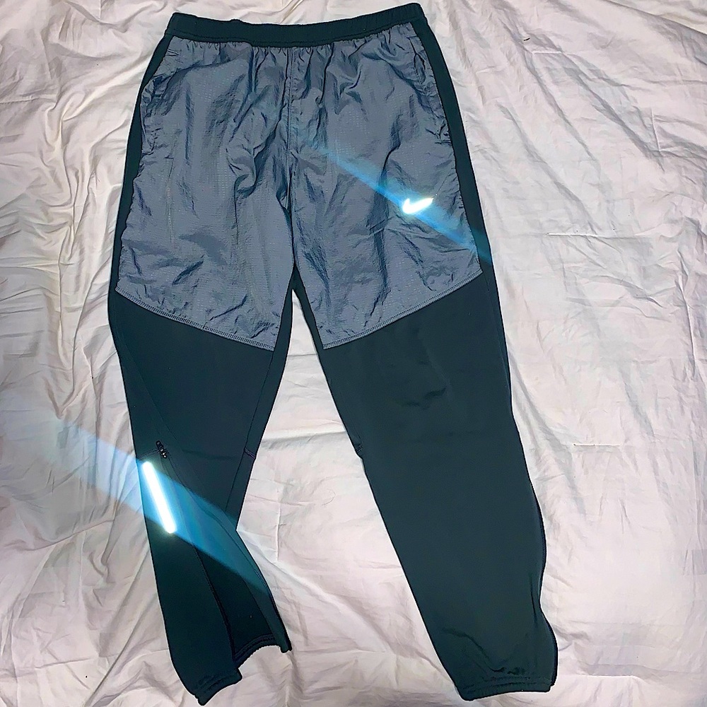 Nike running joggers with reflective panels on front and back